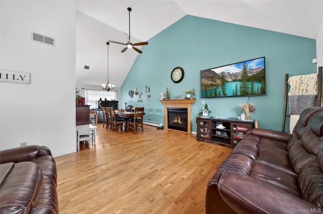 a living room with fireplace furniture and a flat screen tv