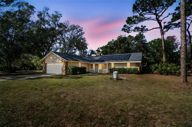 a backyard of a house with table and chairs
