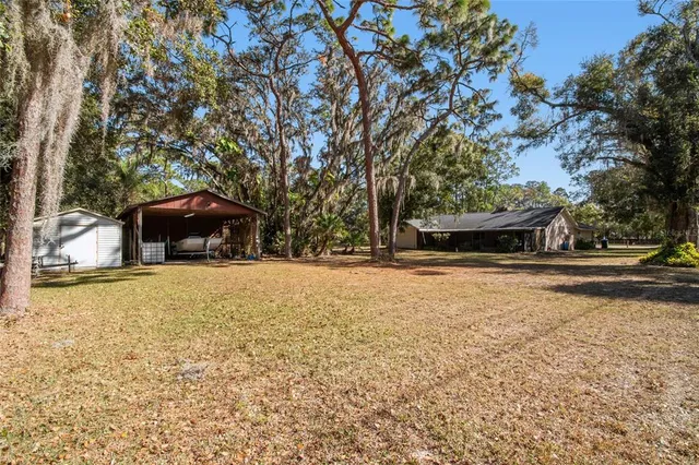 a front view of a house with a yard and potted plants