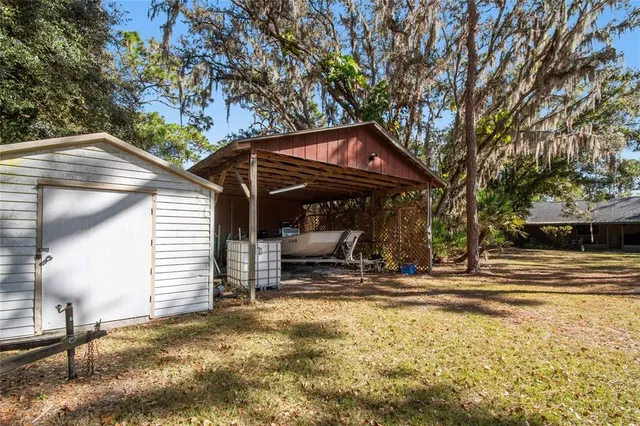 a living room with furniture a fireplace and a large window
