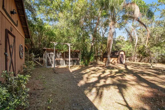 a kitchen with white cabinets a sink dishwasher and a stove with wooden floor