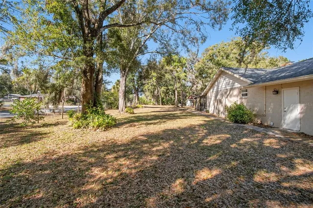 a spacious bedroom with a bed and a flat screen tv