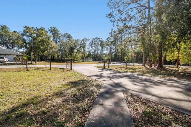 a bedroom with a bed and a mirror on the dresser