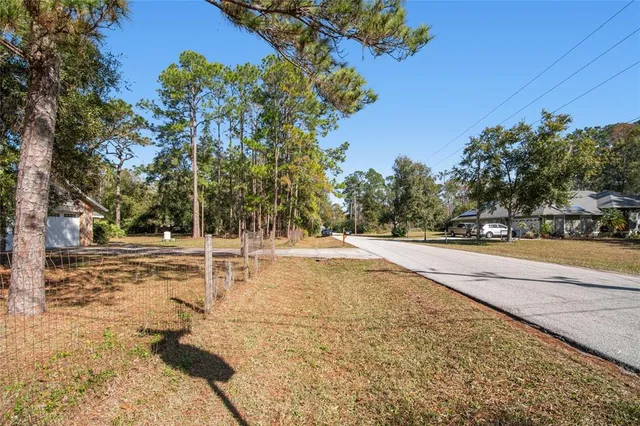 a view of a house with a tree in front of it