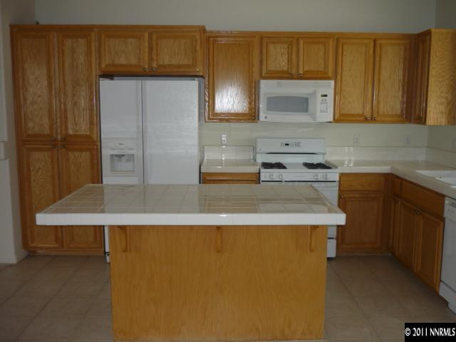2779 Newburgh Way Reno, NV 89523 - Photo 3 of 9 a kitchen with stainless steel appliances granite countertop a sink a stove and a refrigerator
