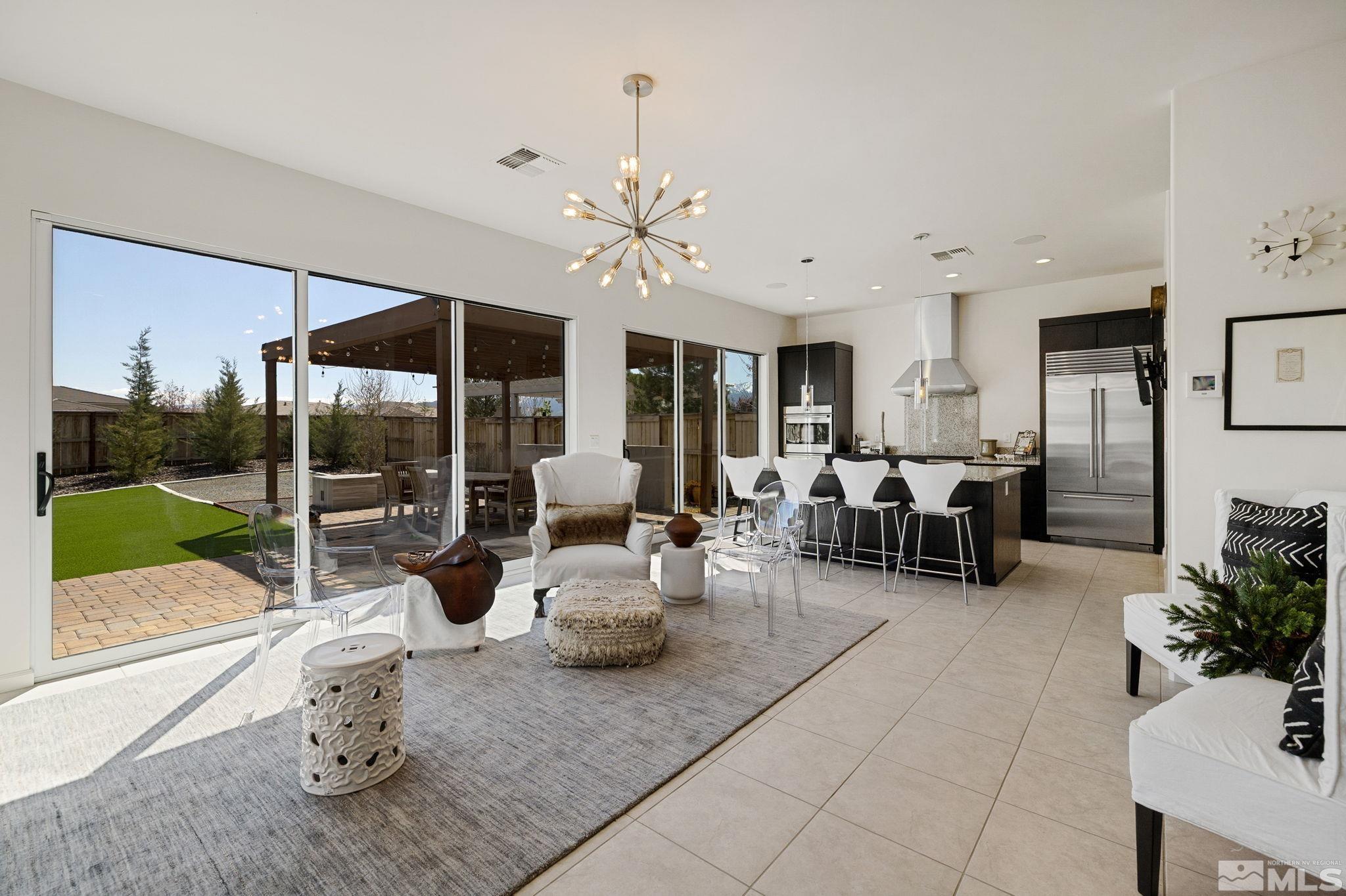 2900 Ethelinda Way Reno, NV 89521 - Photo 8 of 40 a living room with furniture a fireplace and a floor to ceiling window