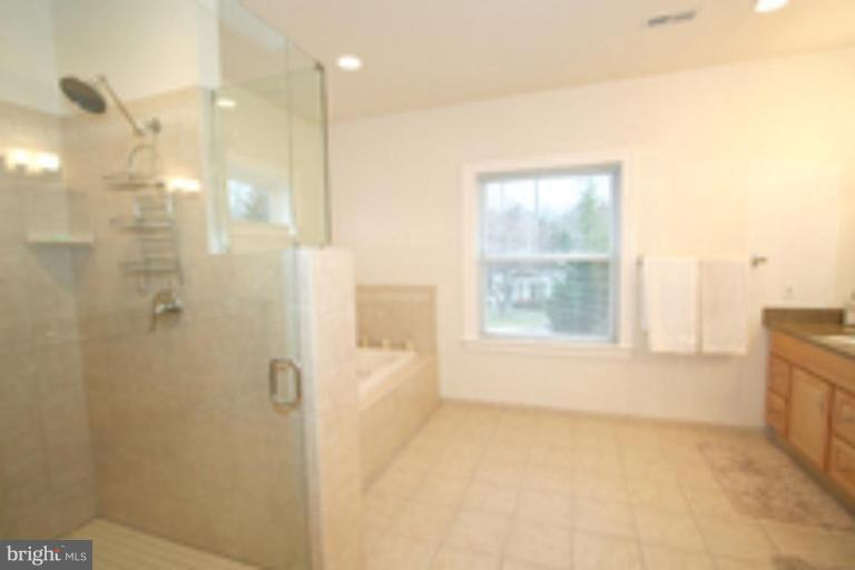 6620 Rannoch Road Bethesda, MD 20817 - Photo 22 of 30 a bathroom with a bathtub and shower