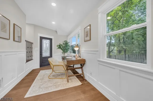 a large white kitchen with kitchen island a sink a stove a dining table and chairs