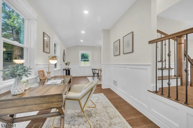 a kitchen with stainless steel appliances kitchen island granite countertop a table chairs sink and cabinets