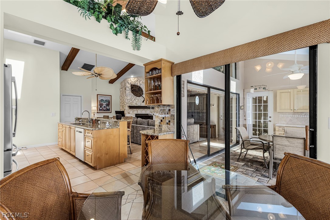 7747 Grande Pine Road Bokeelia, FL 33922 - Photo 13 of 45 a living room with furniture kitchen view and a large window