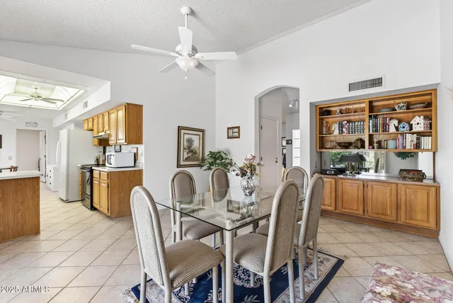 a view of a dining room with furniture and chandelier