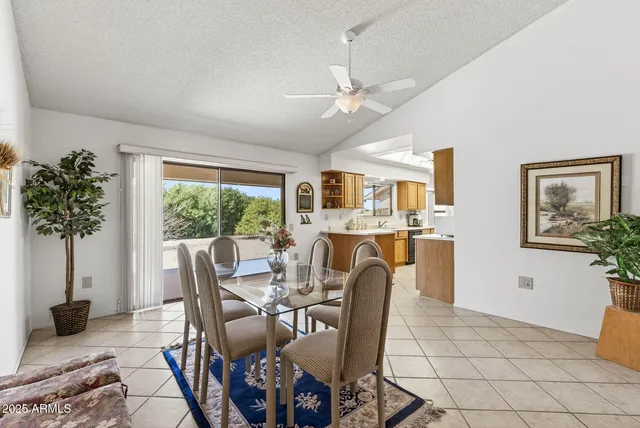 a dining room with furniture potted plants and wooden floor