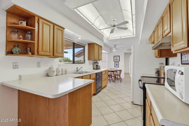 a kitchen with stainless steel appliances a sink stove and cabinets