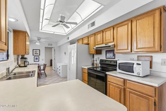 a kitchen with stainless steel appliances granite countertop a sink and cabinets