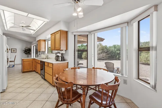 a dining room with furniture a chandelier and window