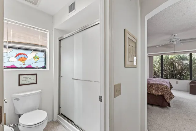 a bathroom with a toilet and a shower curtain
