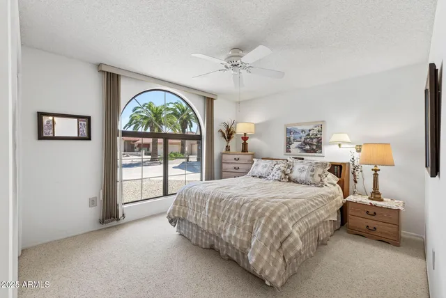 a bedroom with a bed and a large window