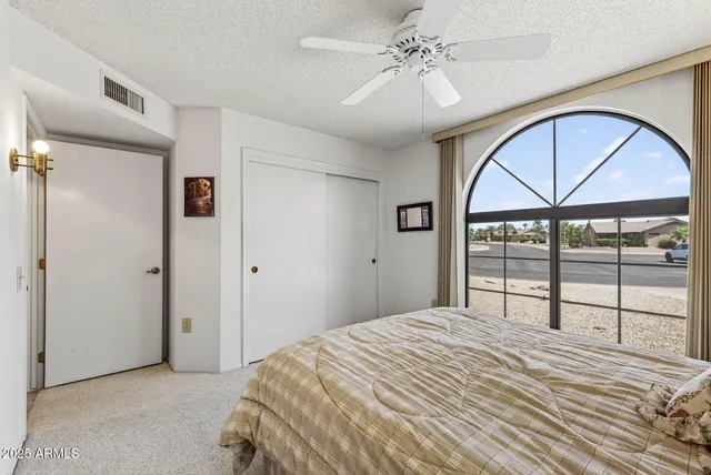 a bedroom with a large bed and a large window