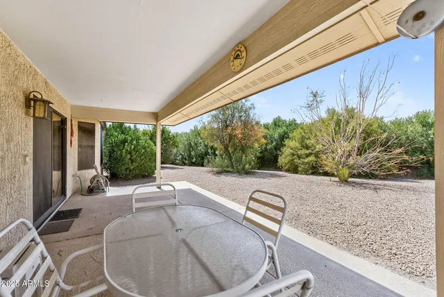a view of swimming pool with outdoor seating and plants
