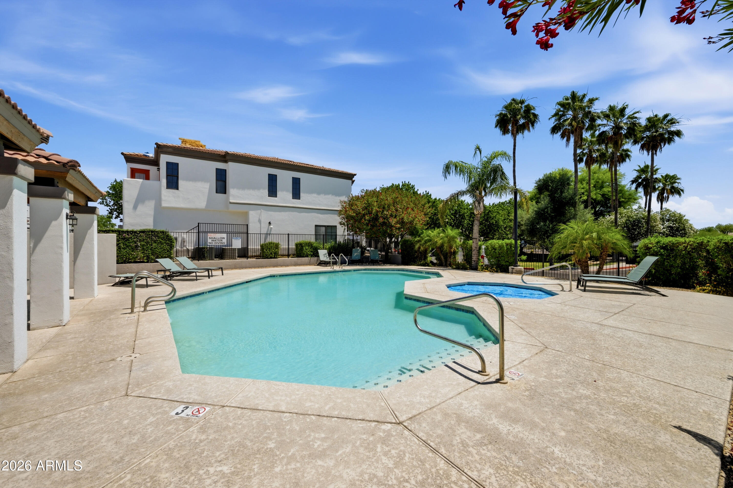 3150 East Beardsley Road, Unit 1009 Phoenix, AZ 85050 - Photo 30 of 31 a view of a swimming pool with lounge chair
