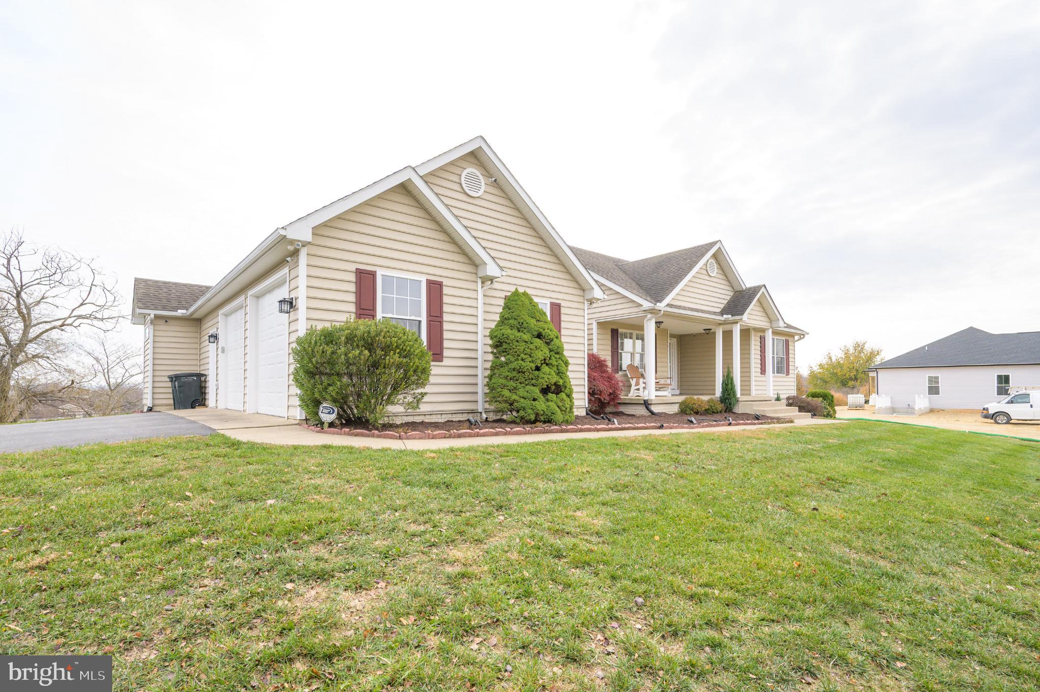 a view of a house with a yard and garage