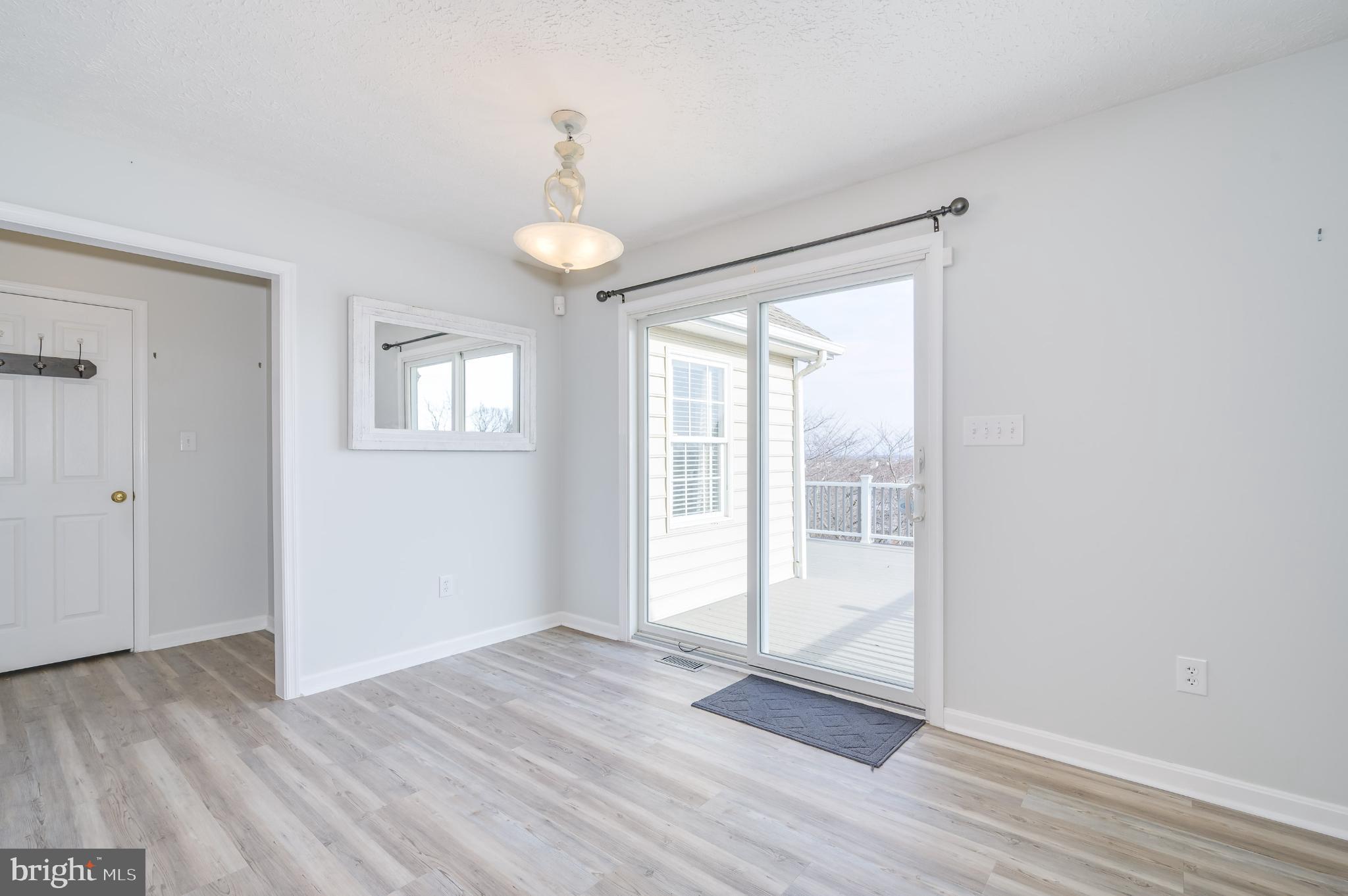 490 Renaissance Drive Martinsburg, WV 25403 - Photo 15 of 73 a view of an empty room with wooden floor and a window