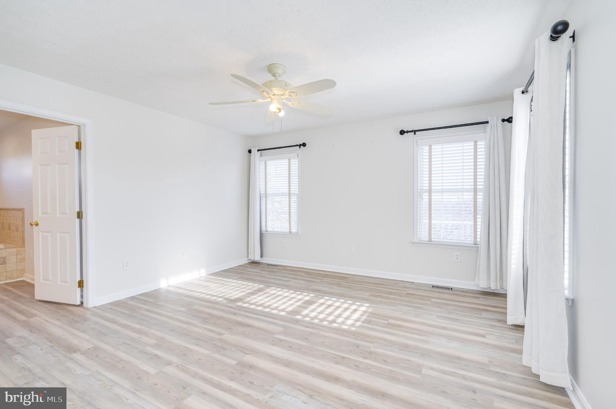 490 Renaissance Drive Martinsburg, WV 25403 - Photo 19 of 73 a view of empty room with wooden floor and fan