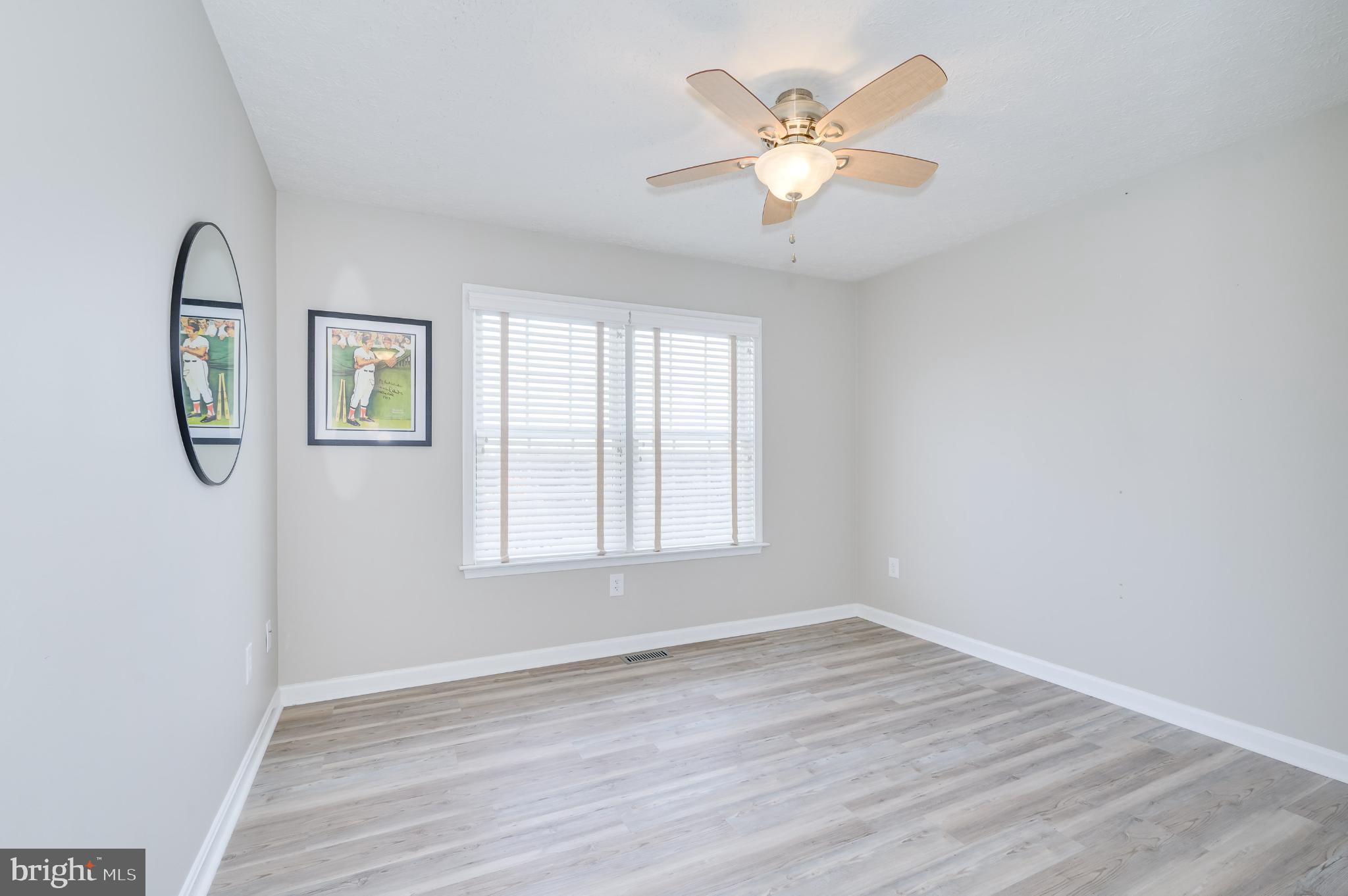 490 Renaissance Drive Martinsburg, WV 25403 - Photo 25 of 73 an empty room with wooden floor and windows
