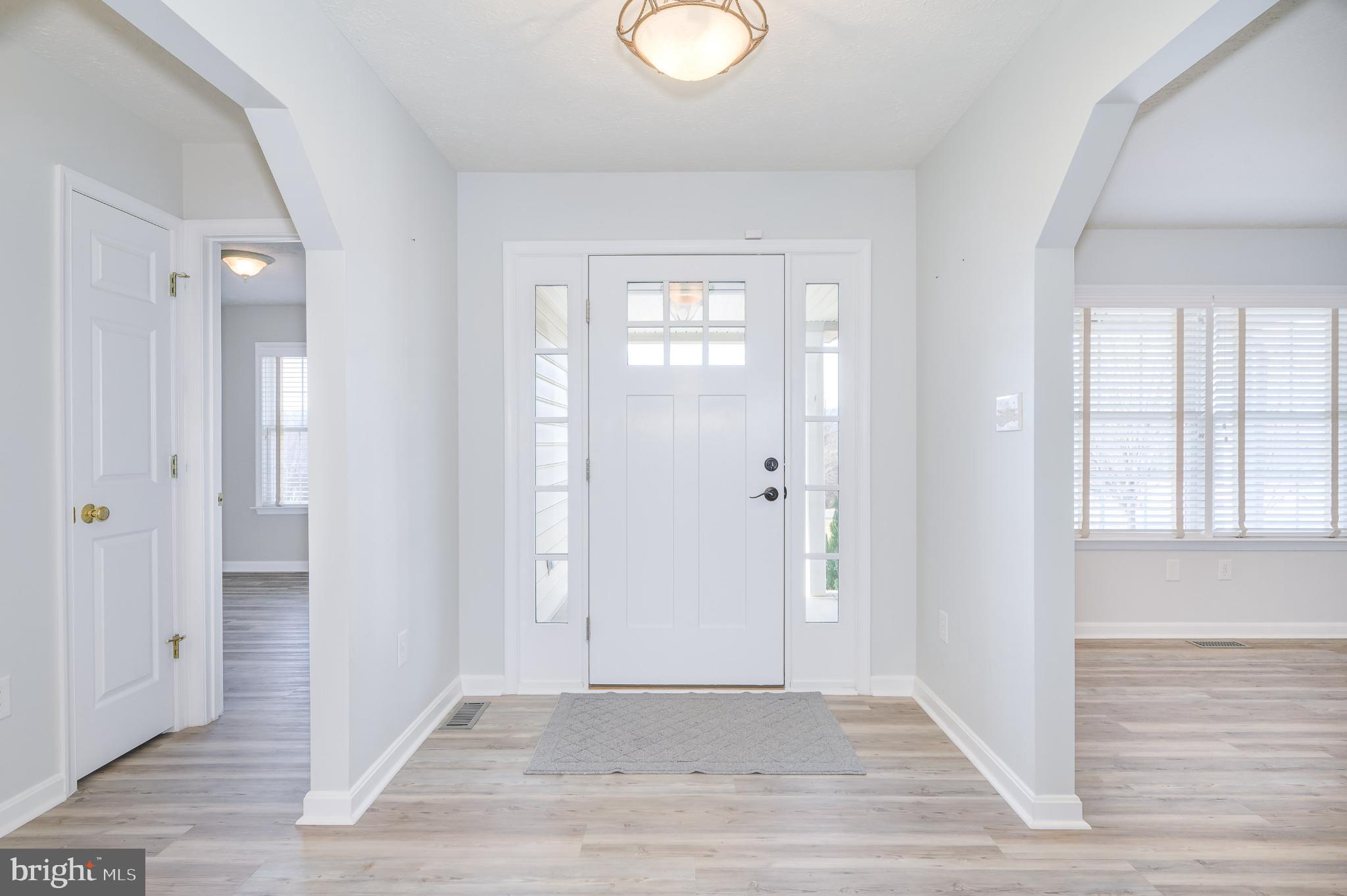 490 Renaissance Drive Martinsburg, WV 25403 - Photo 3 of 73 a view of an empty room with wooden floor and a window