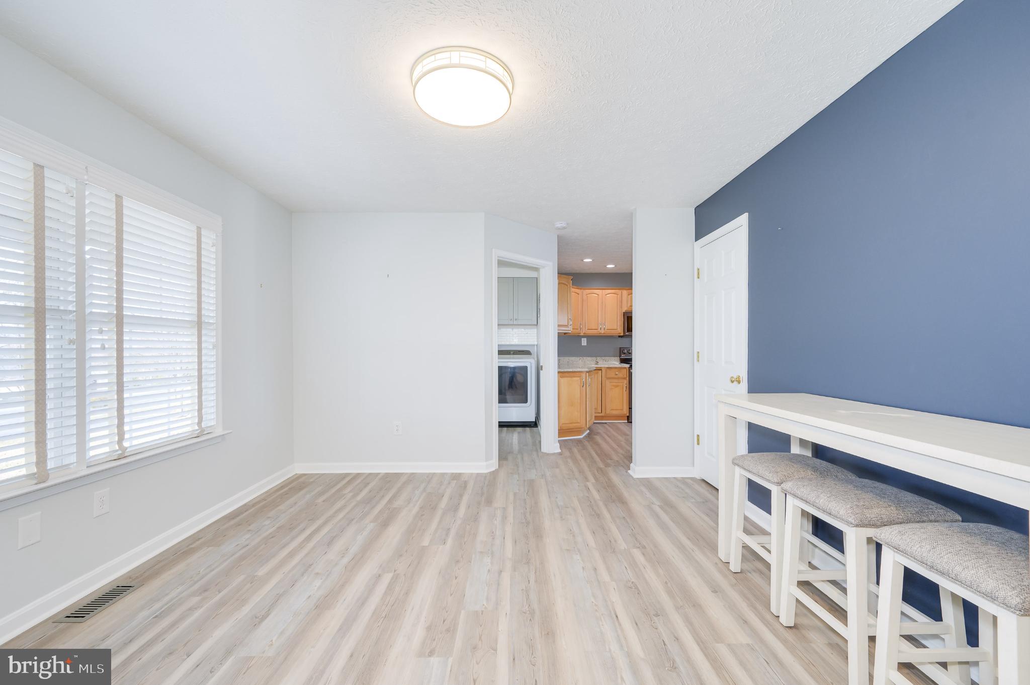 490 Renaissance Drive Martinsburg, WV 25403 - Photo 6 of 73 a view of empty room with wooden floor and windows