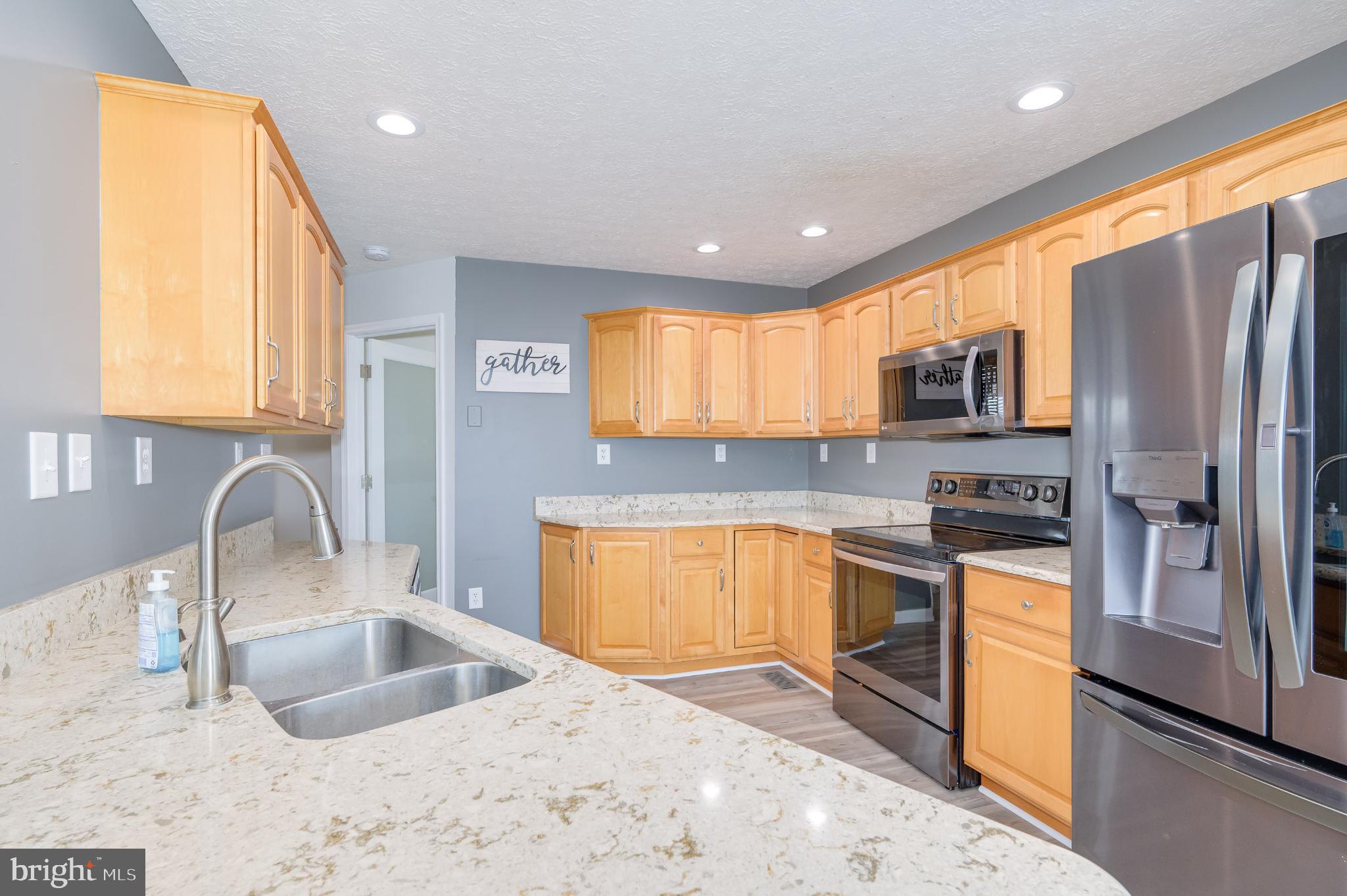 490 Renaissance Drive Martinsburg, WV 25403 - Photo 8 of 73 a kitchen with stainless steel appliances granite countertop a sink refrigerator stove and microwave