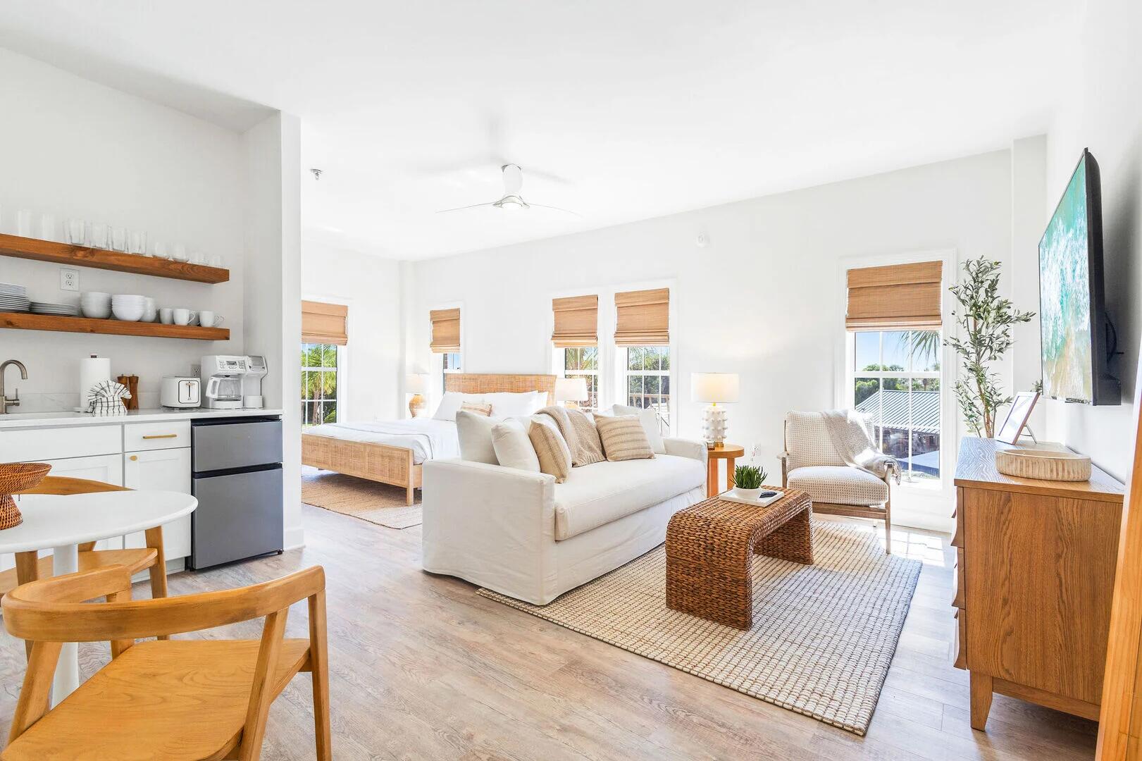 a living room with furniture wooden floor and a large window