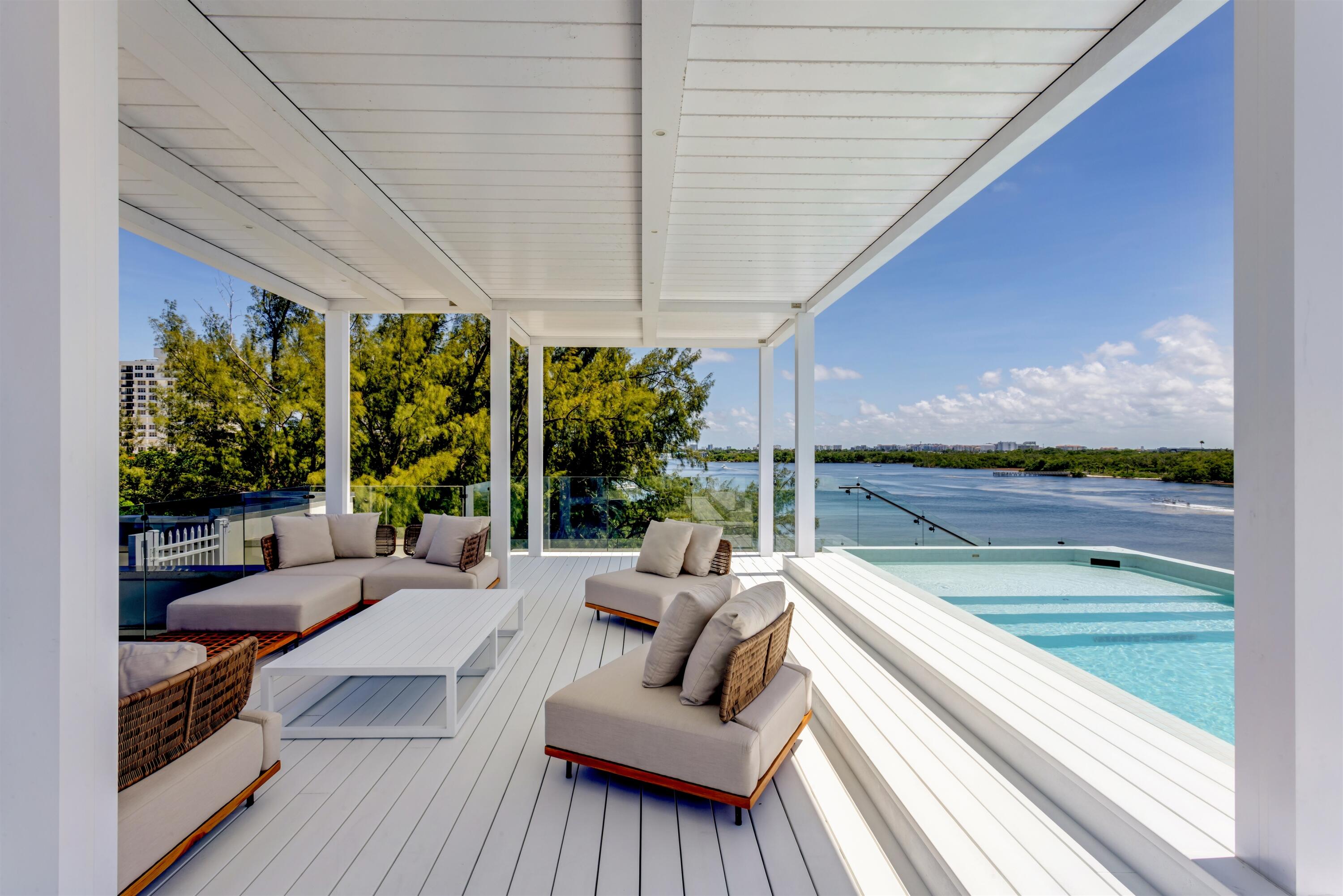 900 Lago Mar Lane, Unit PH Boca Raton, FL 33431 - Photo 40 of 58 a outdoor living space with furniture and garden view