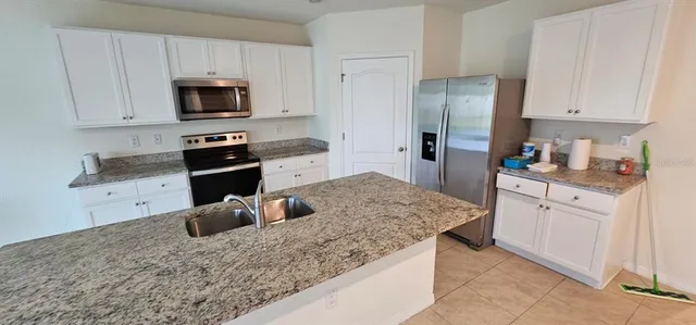 a view of a livingroom with wooden floor and a ceiling fan