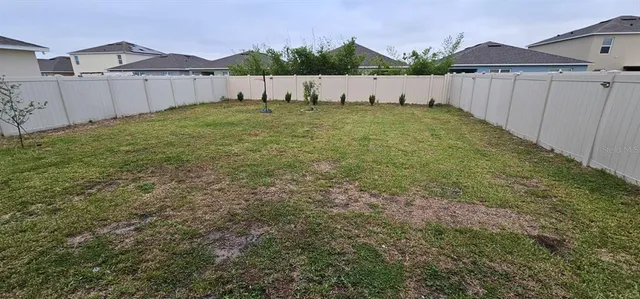 a view of a house with a yard and garage