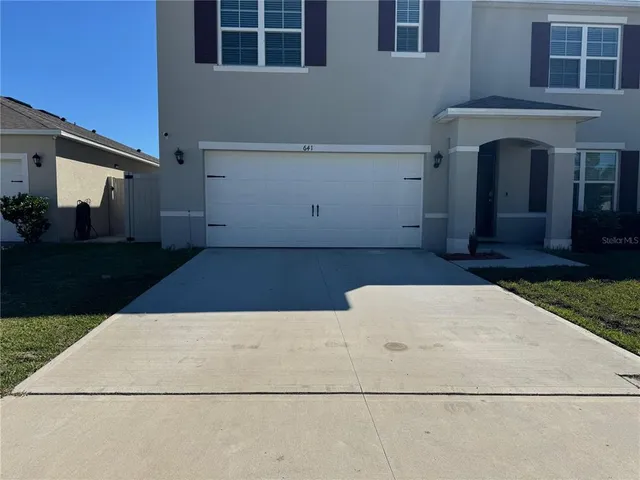 a kitchen with stainless steel appliances granite countertop a sink counter space cabinets and a large window