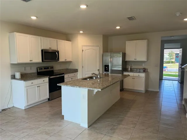a kitchen that has a lot of cabinets in it