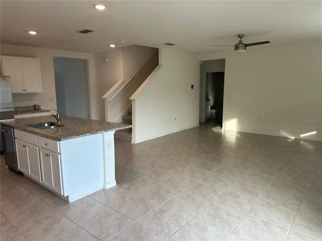a kitchen with sink cabinets and microwave