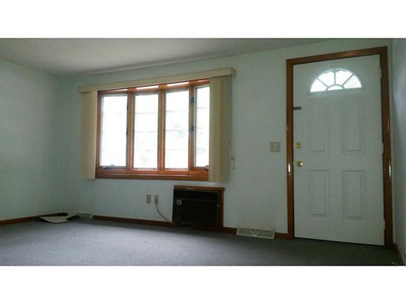 14 Lydia Road Coventry, RI 02816 - Photo 4 of 13 Living Room. SPACIOUS LIVING ROOM, BAY WINDOW, A/C WALL UNIT, NEWER DOOR, ACTUALLY HARDWOODS UNDER CARPET!