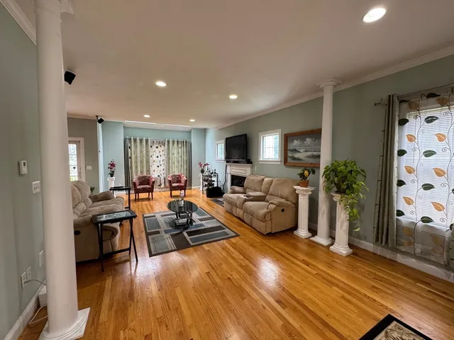 a living room with furniture and wooden floor