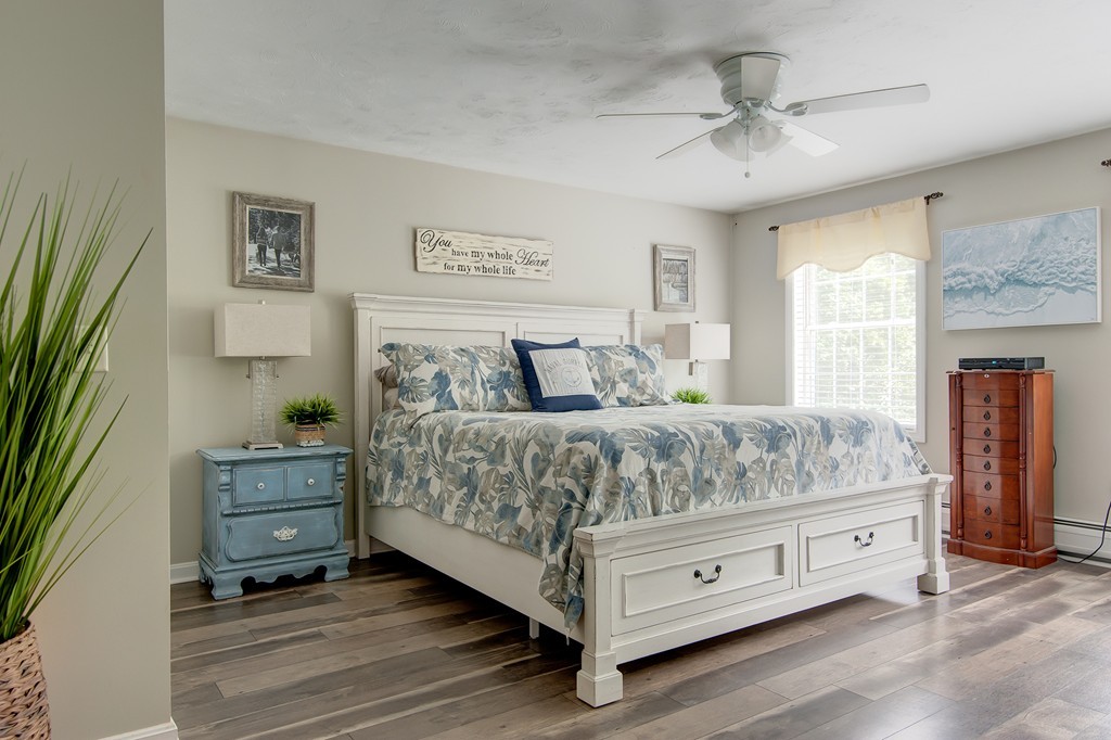 6 Vinton Road Sturbridge, MA 01566 - Photo 13 of 20 a bedroom with a bed and a chandelier