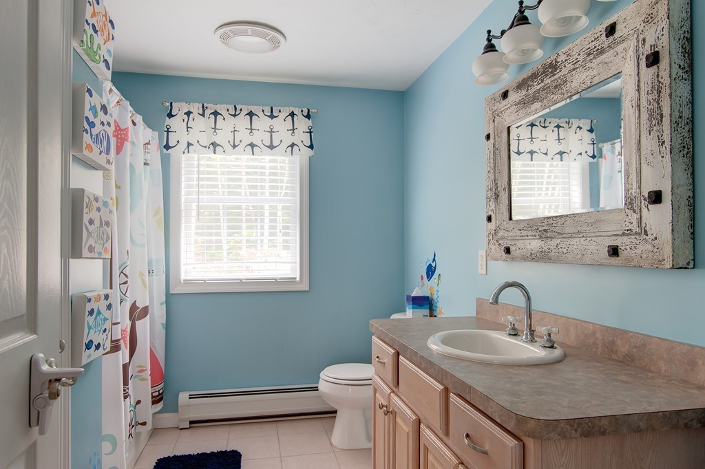 6 Vinton Road Sturbridge, MA 01566 - Photo 19 of 20 a bathroom with a toilet sink and mirror