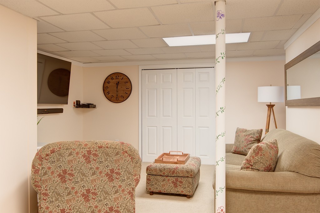 6 Vinton Road Sturbridge, MA 01566 - Photo 20 of 20 a living room with a couch and a chandelier
