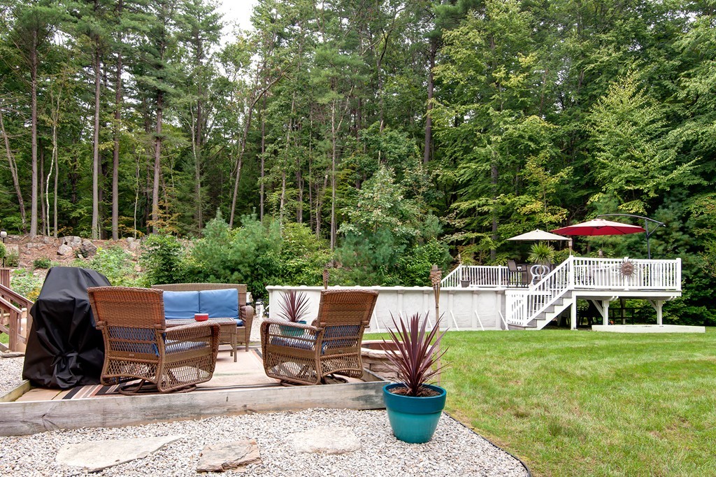 6 Vinton Road Sturbridge, MA 01566 - Photo 4 of 20 a view of a patio with table and chairs potted plants and large tree