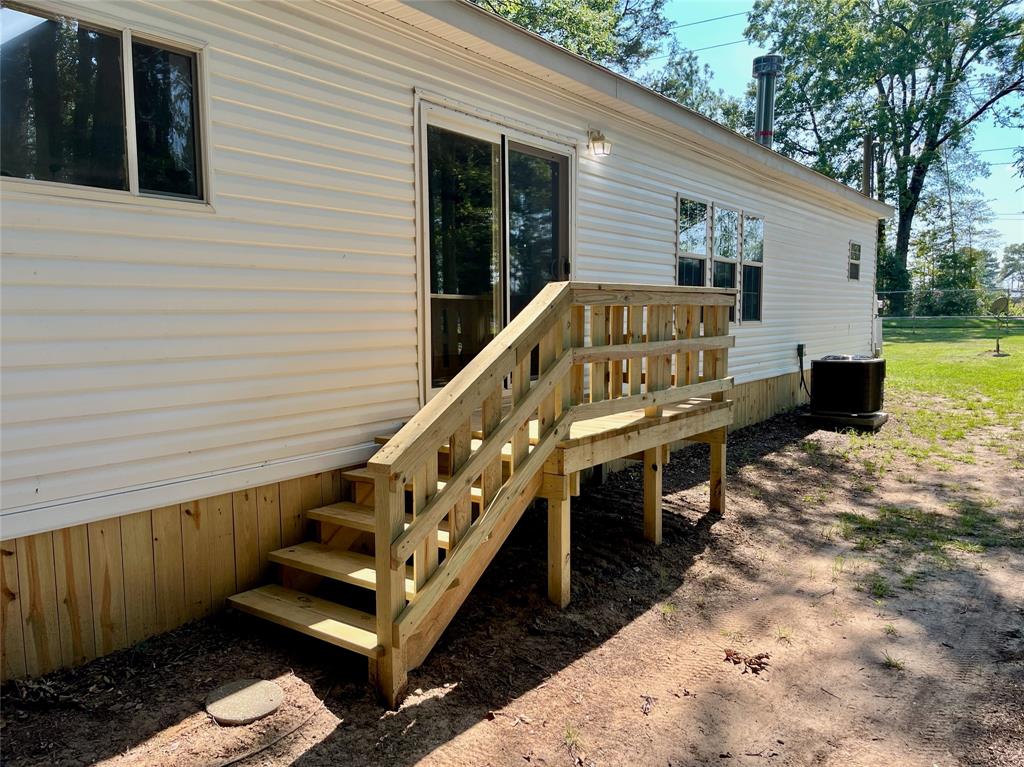 6913 Rice Road Shreveport, LA 71129 - Photo 4 of 26 a view of a house with wooden deck and furniture
