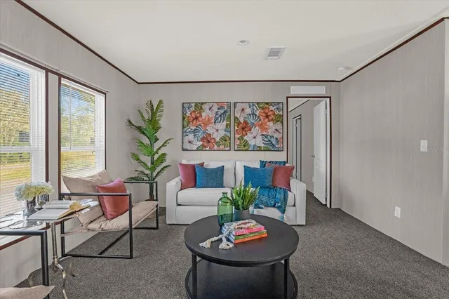 a living room with furniture and a potted plant