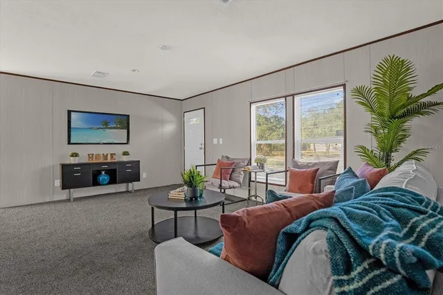 a living room with furniture and large windows