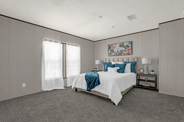 a bed room with a bed and a large window