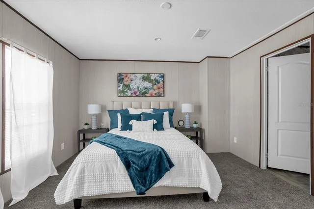 a bedroom with a bed and a painting