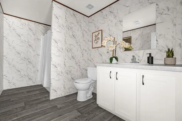 a bathroom with a sink toilet and shower